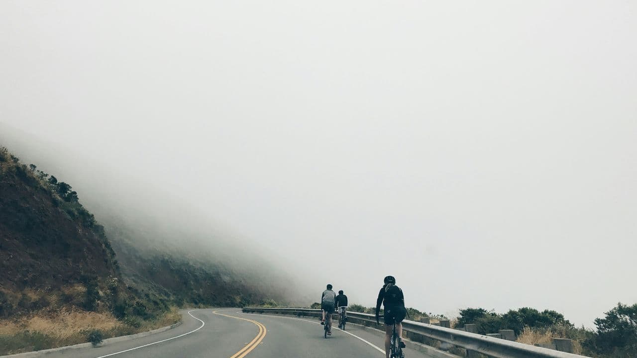 three-men-biking-on-asphalt-road-95-YnGEj-wA